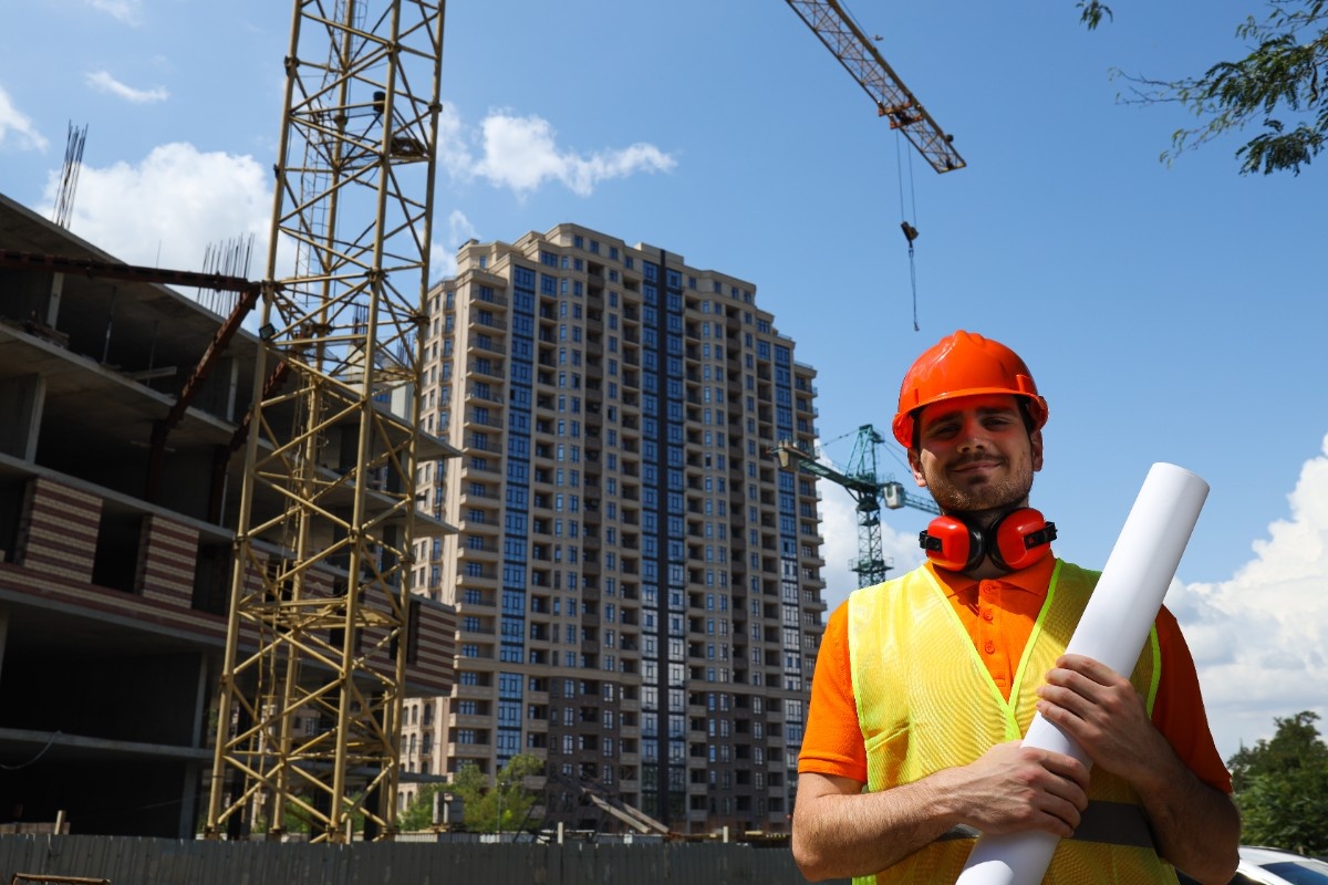 Construction site with workers and cranes